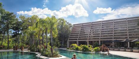 A swimming pool with a modern building in the background.