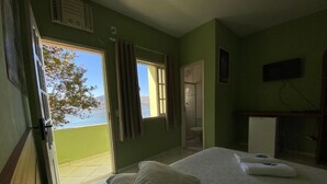 Een kamer met een bed, een televisie en uitzicht op het omliggende landschap.
