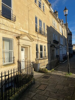 A historic building with a stone facade, multiple windows, and a black metal fence. - Chic Georgian Escape, Central Bath (Bath)
