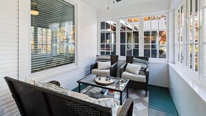 A sunroom with a ceiling fan, large windows, wicker furniture, and a glass coffee table. - Spacious downtown loft, with soaking tub&gym access-walk to BSU and Boise River! (Boise)