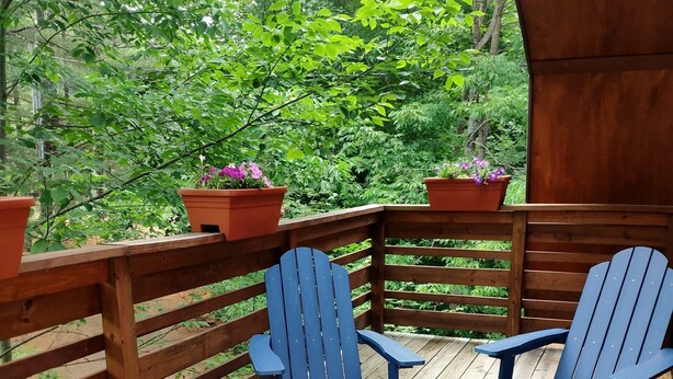 A wooden deck with two Adirondack chairs and two potted plants. - Camp Lily, Whiteface-Vacation, Modern  Apartment, Perfect 2 bedroom with AC (Wilmington)