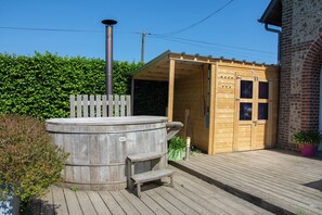 A wooden hot tub, a wooden deck, a brick building, and a wooden shed. - Armand's barn (Mentheville)