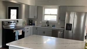 Coffee/tea maker, fridge, microwave, oven - Spacious 4-bedroom house steps away from the water at beautiful Fort Scott Lake. (Fort Scott)
