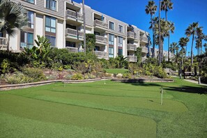 A golf course with a building in the background. - North Coast Village D204 (Oceanside)