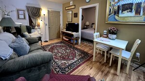 A cozy living room with a sofa, TV, and dining table. - Private and cozy stay 2-bedroom apartment with AC in Oklahoma City (Oklahoma City)