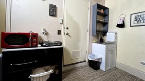 A compact kitchenette with a microwave, stove, and sink. - Private and cozy stay 2-bedroom apartment with AC in Oklahoma City (Oklahoma City)