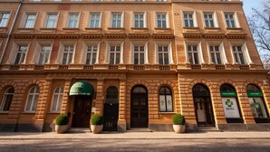 A multi-story building with a classical architectural style, featuring symmetrical windows and decorative moldings. - Maroon & Moss Residence (Budapest)