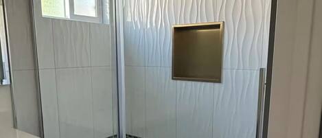 Shower, hair dryer, towels, toilet paper
