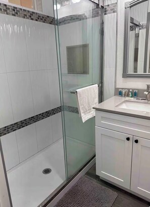 Shower, hair dryer, towels, toilet paper