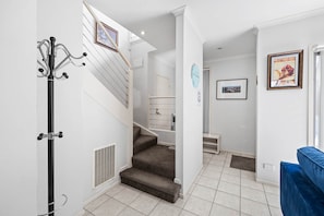 A staircase with a handrail, a coat rack, and a wall-mounted picture frame. - Sleep 5 | Luxury Box Hill Townhouse (Box Hill)