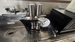 A kitchen with a stainless steel sink, a dish rack with utensils, and a black dishwasher. - Lake View Entire House｜Relaxing Private Stay in Nature (Minamikomatsu, Otsu City)