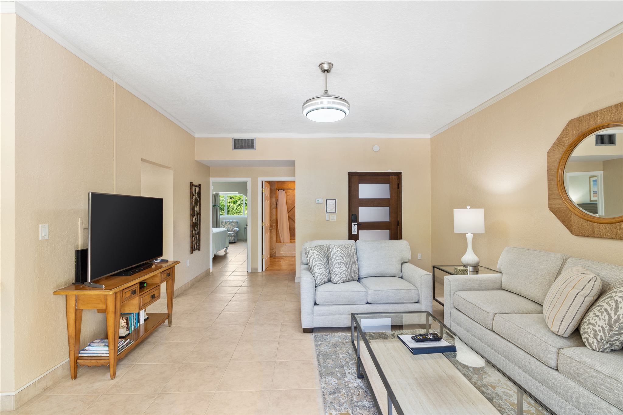 A living room with a television, sofa, and coffee table.