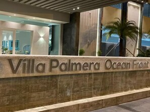 A stone sign with the text "Villa Palmera Ocean Front" indicating the name of the property. - Juan Dolio Executive One Bedroom Suite With Ocean Views. (Juan Dolio)