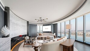 A modern hotel room with a curved ceiling, a large window offering a city view, a sofa set, a coffee table, and a TV screen. - Oryard Hotel Changsha Juzhou (Changsha)