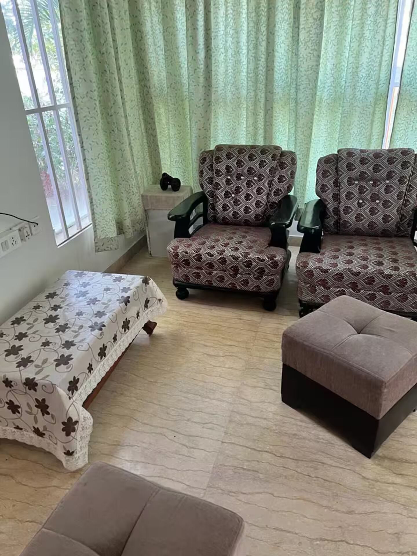 A living room with a sofa set, a coffee table, and a side table.