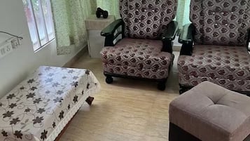 A living room with a sofa set, a coffee table, and a side table.