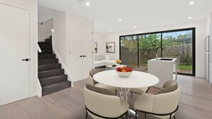 A modern kitchen with a white countertop, a built-in oven, and a stainless steel refrigerator. - French home walking to shops and shopping center (Maidstone)