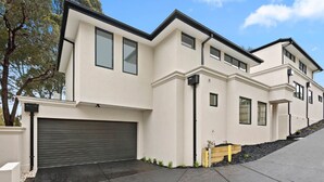 A modern two-story house with a garage, large windows, and a well-maintained driveway. - French home walking to shops and shopping center (Maidstone)