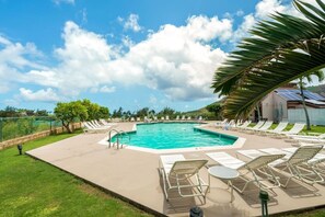 A swimming pool with lounge chairs and a palm tree. - Just Listed! Banyan Retreat at Kalapaki Bay Beach (Lihue)