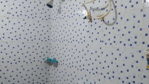 A bathroom with a toilet, shower, and tiled walls. - Holidayhomecochin  (Kanayannur)