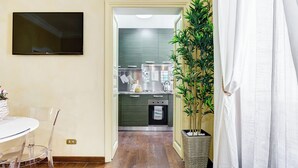 A modern kitchen with dark cabinets, a stainless steel range, and a built-in oven. - PIAZZA DI SPAGNA FABULOUS AND COZY APARTMENT (Roma)