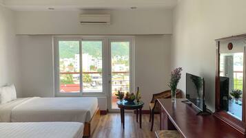 Family Room, Partial Ocean View | Minibar, in-room safe, desk, laptop workspace