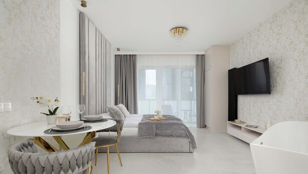 Moderni hotellihuone, jossa on ruokailutila, suuri sänky, televisio ja kylpyhuone.