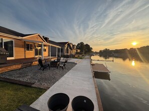A lakeside property with a patio, outdoor seating, and a dock. - River Trail Retreat by the Bay (Bay City)