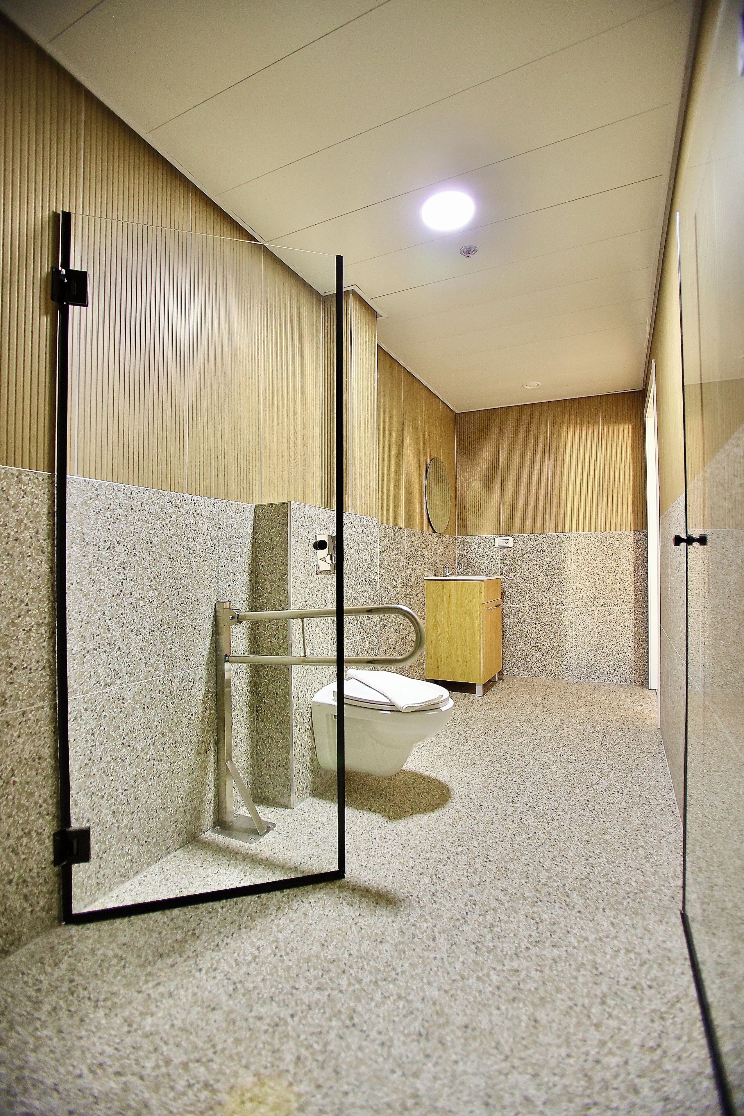 Une salle de bain moderne avec des toilettes, un lavabo et un miroir.