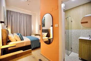 A hotel room with a bed, a mirror, a bathroom with a shower, and a sink. - Azura Boutique Hotel (Tiberias)