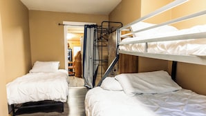 A room with two bunk beds, wooden flooring, and a door leading to a hallway. - Perfect 3-bedroom house in Hope for a relaxing getaway (Hope)