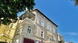 A multi-story building with a corner entrance, a visible staircase, and a street view. - Villa Sokol - Belle Epoque studio (Opatija)