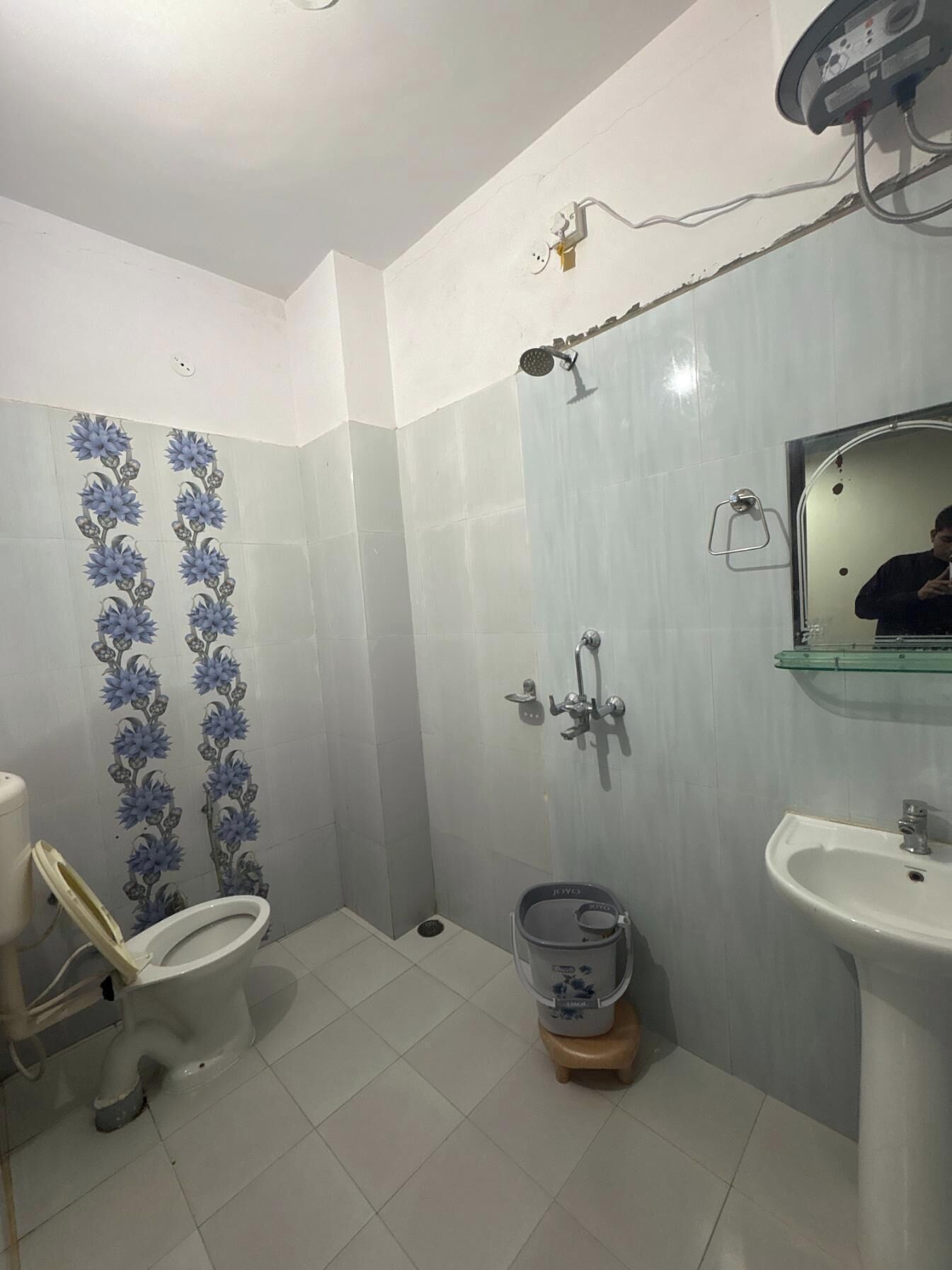 Ein Badezimmer mit Toilette, Waschbecken, Dusche und Spiegel.