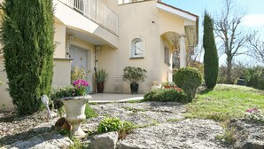 A building with a balcony, a door, and potted plants. - Bed and Breakfast 'Maison D'hotes Dolce Vita' with Mountain View, Shared Pool and Wi-Fi (Veyssilieu)