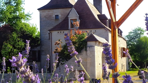 A stone building with a tower, surrounded by lavender fields. - Quercy Room – Romantic & Authentic Retreat (Gramat)