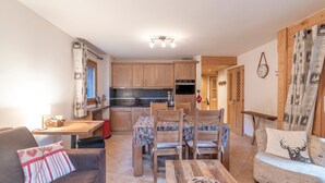 Un salon confortable avec un canapé, une table basse et un coin repas comprenant des chaises et une table.
