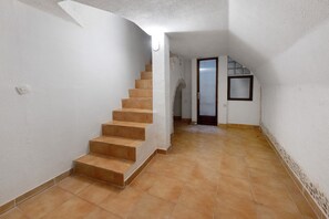 A staircase leading to a landing with a door and a window.