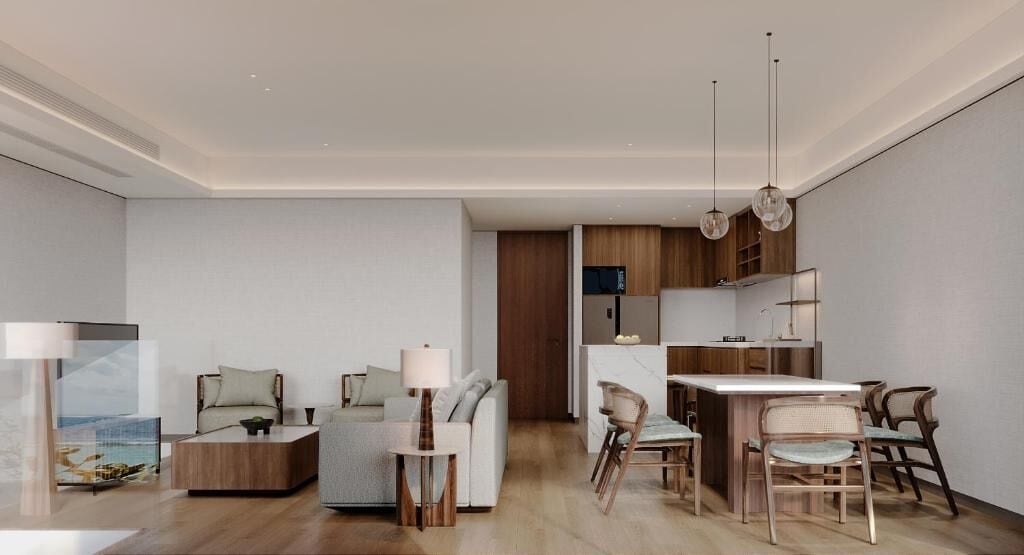 A modern living room with a sofa, coffee table, and dining area with chairs. There is a kitchen in the background with wooden cabinets and a refrigerator.