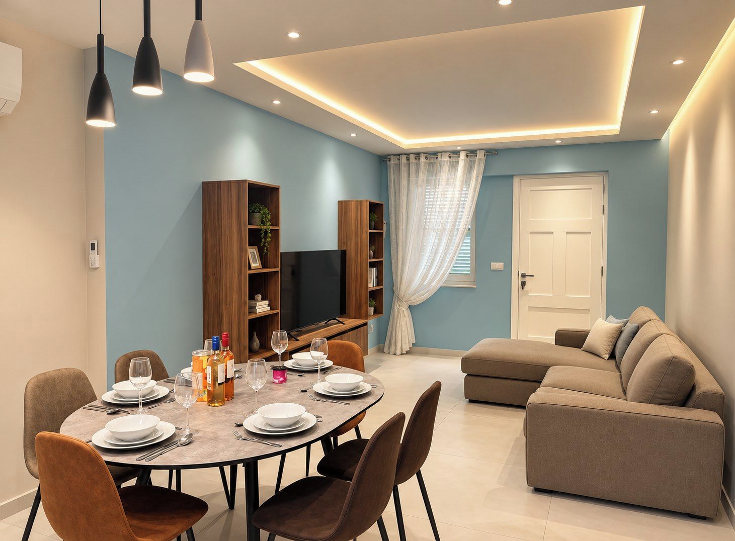A modern living room with a dining area, a sofa, and a TV.