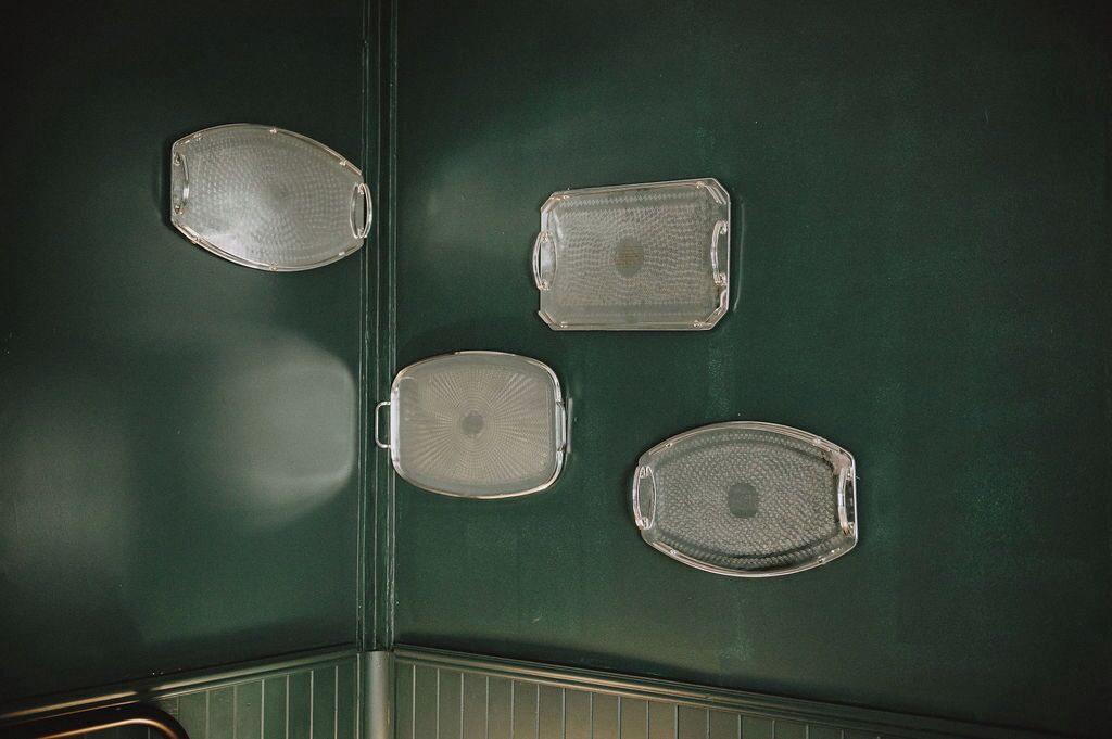 A green wall with four clear, textured panels.
