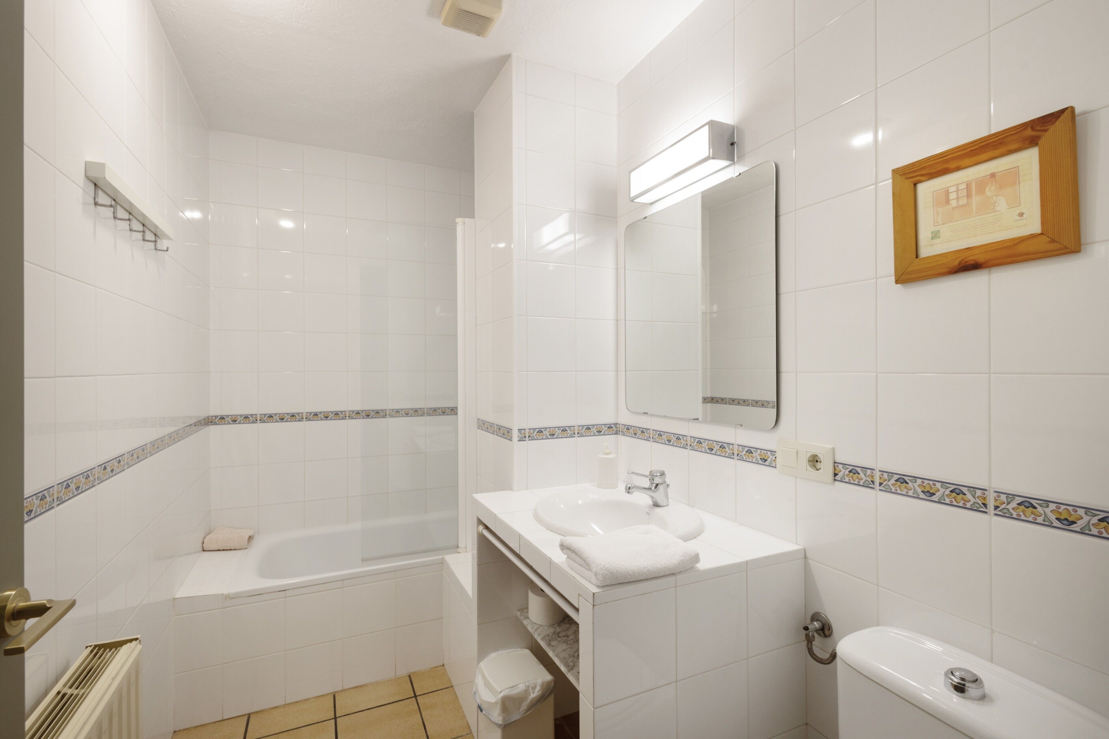 A bathroom with a bathtub, a sink, a toilet, and a shower.