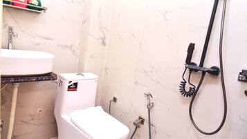Deluxe Single Room | Bathroom | Shower, slippers, towels, soap
