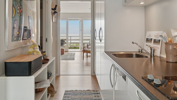 A modern kitchen with stainless steel appliances, a built-in oven, and a large window offering a view of the outdoors. - "Ømund" - 100m from the sea by Interhome (Allinge)