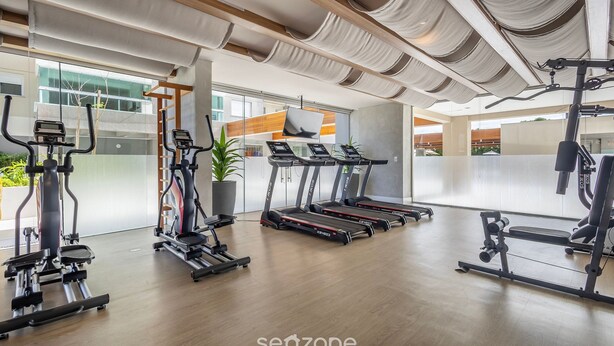 A modern gym with treadmills, elliptical machines, and weight equipment. - Cond. c/ Academia a apenas 200 m da Praia de Piçarras - PTCs (Picarras)