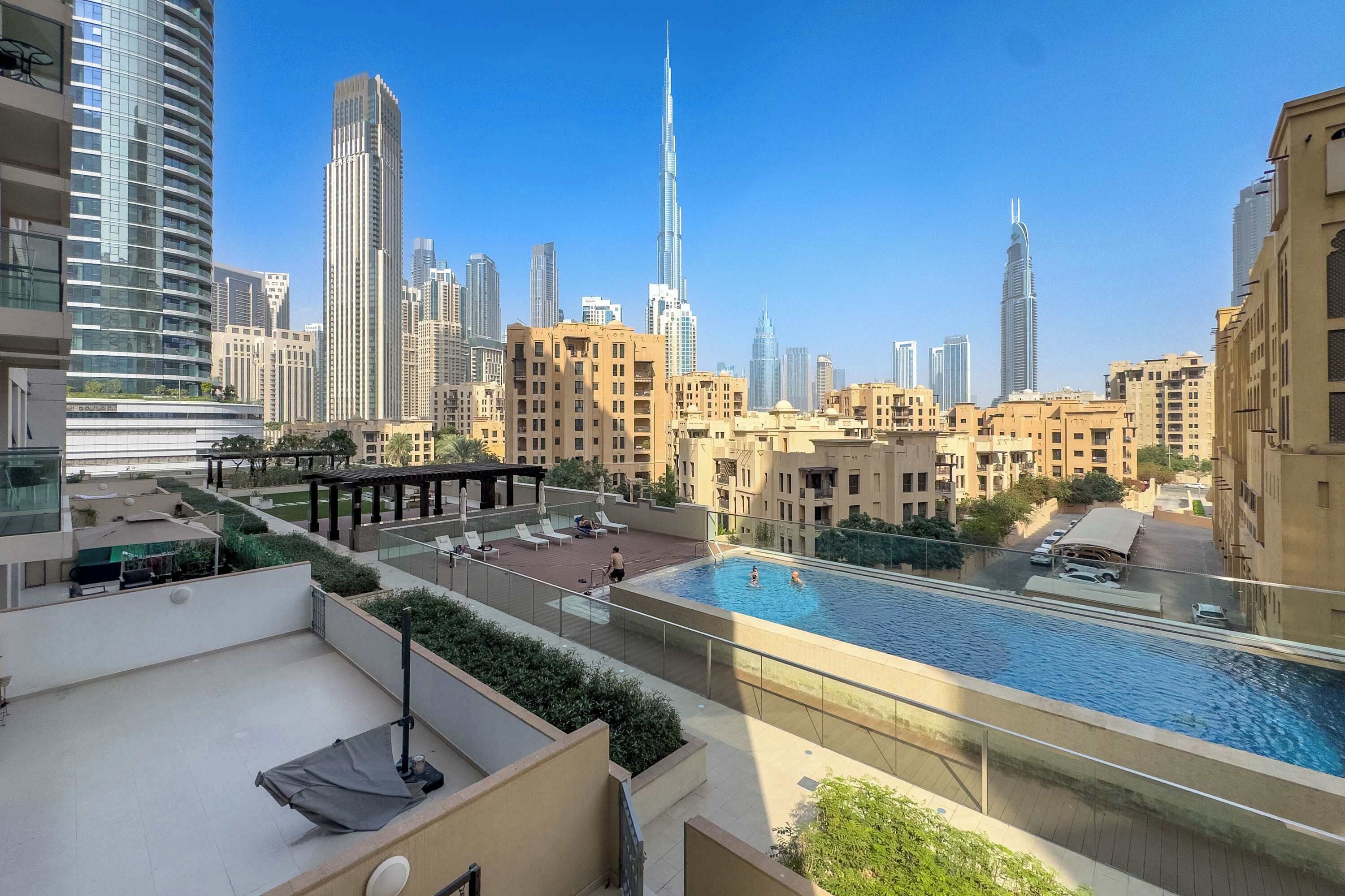 A rooftop pool with a city skyline in the background.
