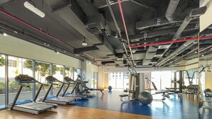 A gym with treadmills, exercise balls, and weight machines. - StayShort - Downtown 2 Bed Unit with Burj Views that Sleeps 4 (Downtown)