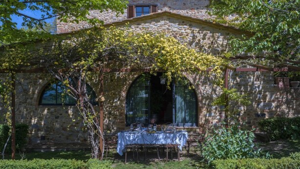 A stone building with a covered outdoor seating area.