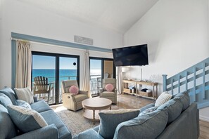 A living room with a sofa, chairs, a coffee table, and a TV. - 2 story condo with Epic Gulf Views in Crystal Villas B13 (Destin)
