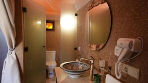 A bathroom with a large bowl sink, a mirror, a hairdryer, and a toilet. - Deluxe family suite with private pool  in agafay (Agafay)