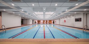 A large indoor swimming pool with clear lanes, a tiled floor, and a ceiling with recessed lighting. - Grand Mercure Wuxi Huishan (Wuxi)